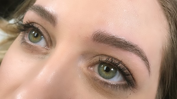 Eyes of a beautiful girl after applying eyeliner and permanent eyebrows