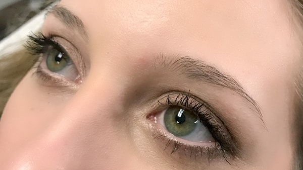 Eyes of a beautiful girl without applying eyeliner and permanent eyebrows