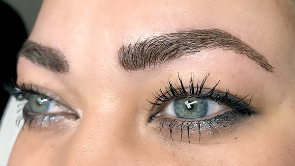 Image of eyes after using eyeliner and permanent eyebrows
