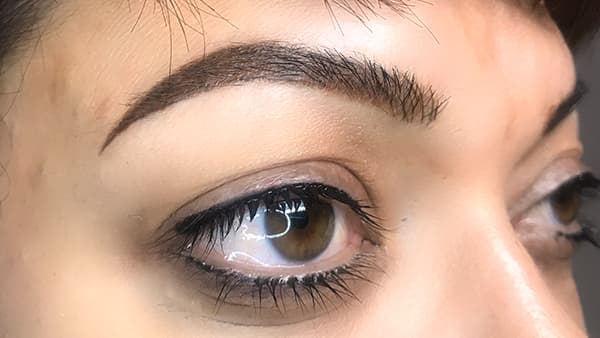 Sample image of eyes after applying eyeliner and permanent eyebrows